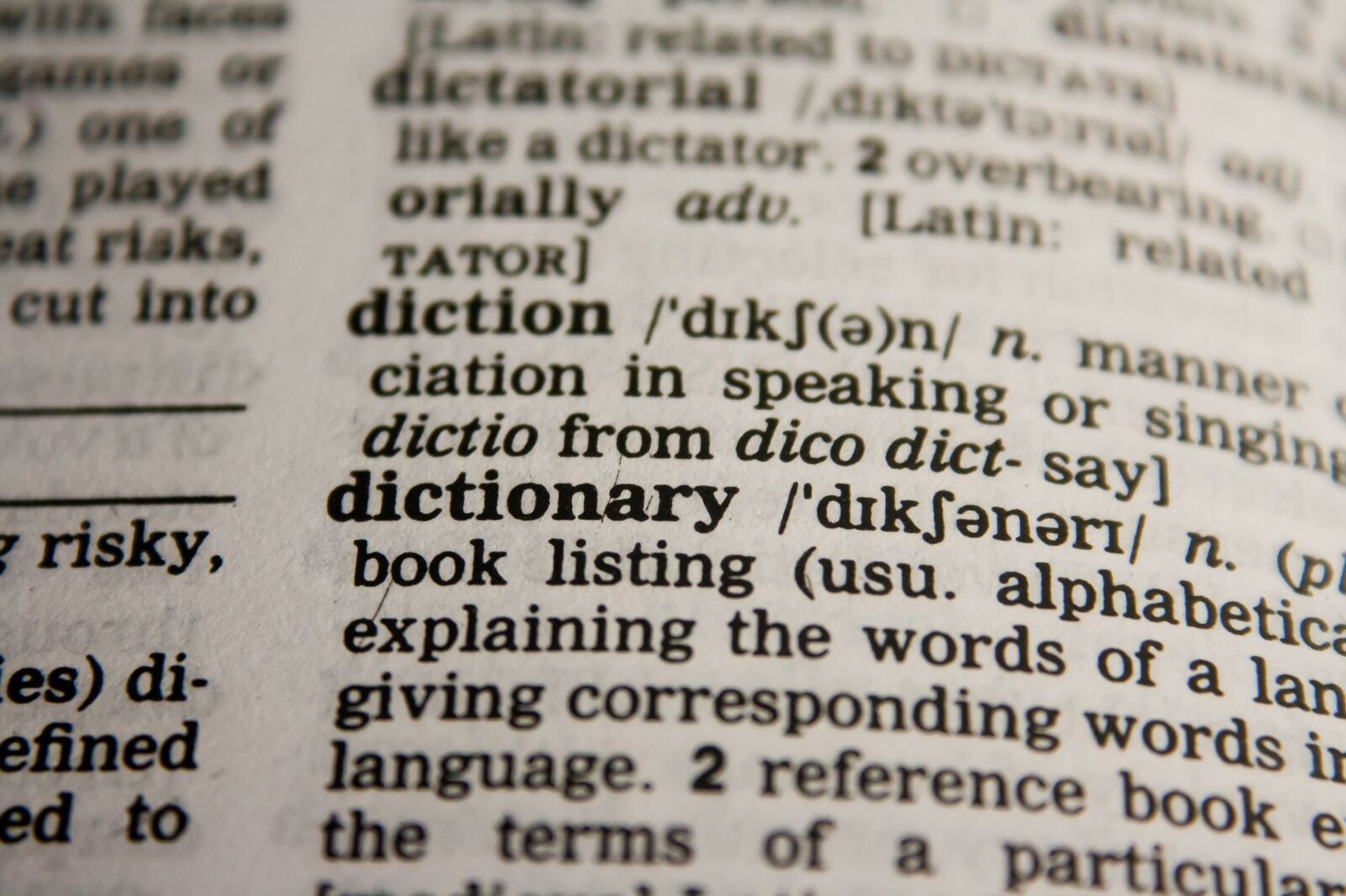 Close-up of a dictionary page open at the entry for the word "dictionary"
