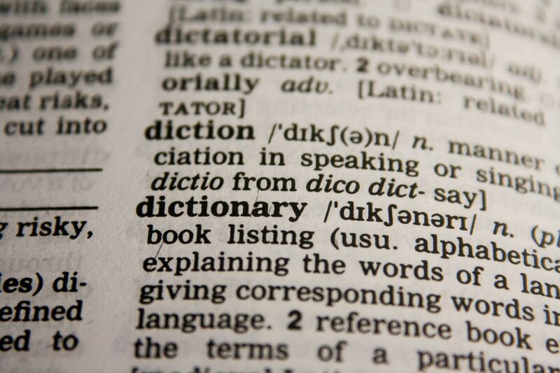 Close-up of a dictionary page open at the entry for the word "dictionary"